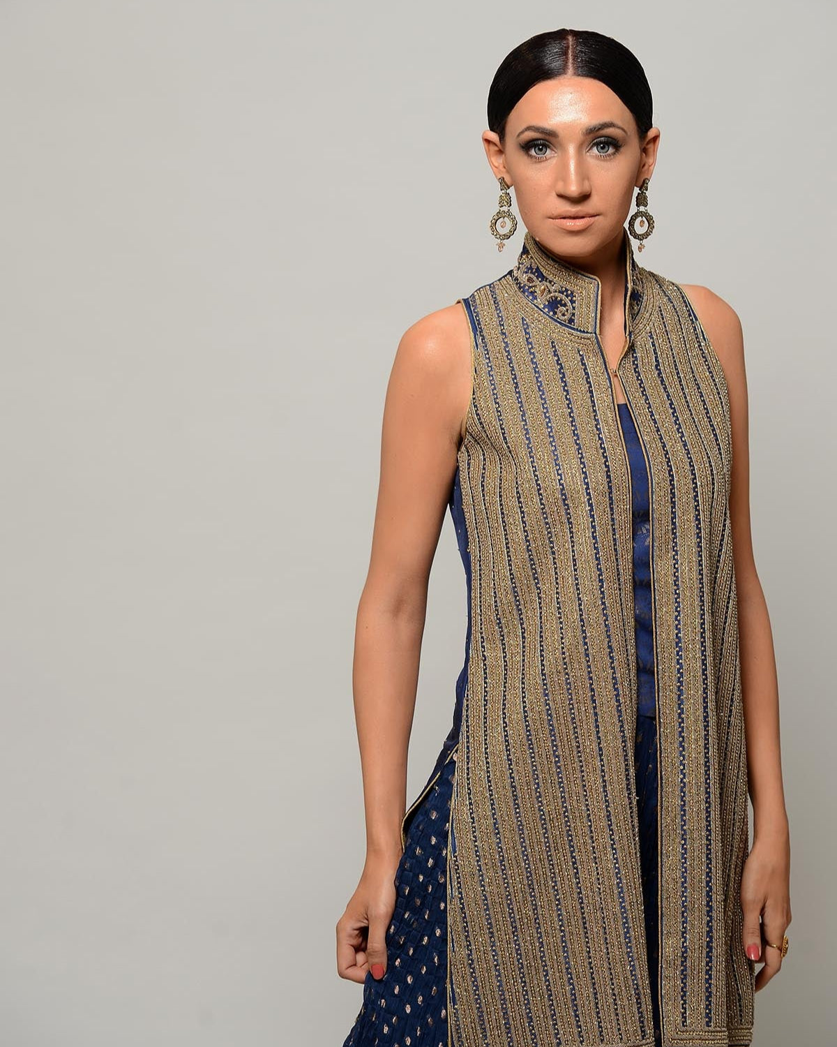 Woman wearing a patterned sleeveless top with a plain background