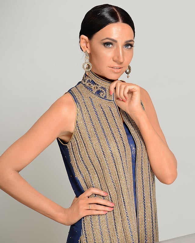 Woman wearing a patterned sleeveless top against a plain background