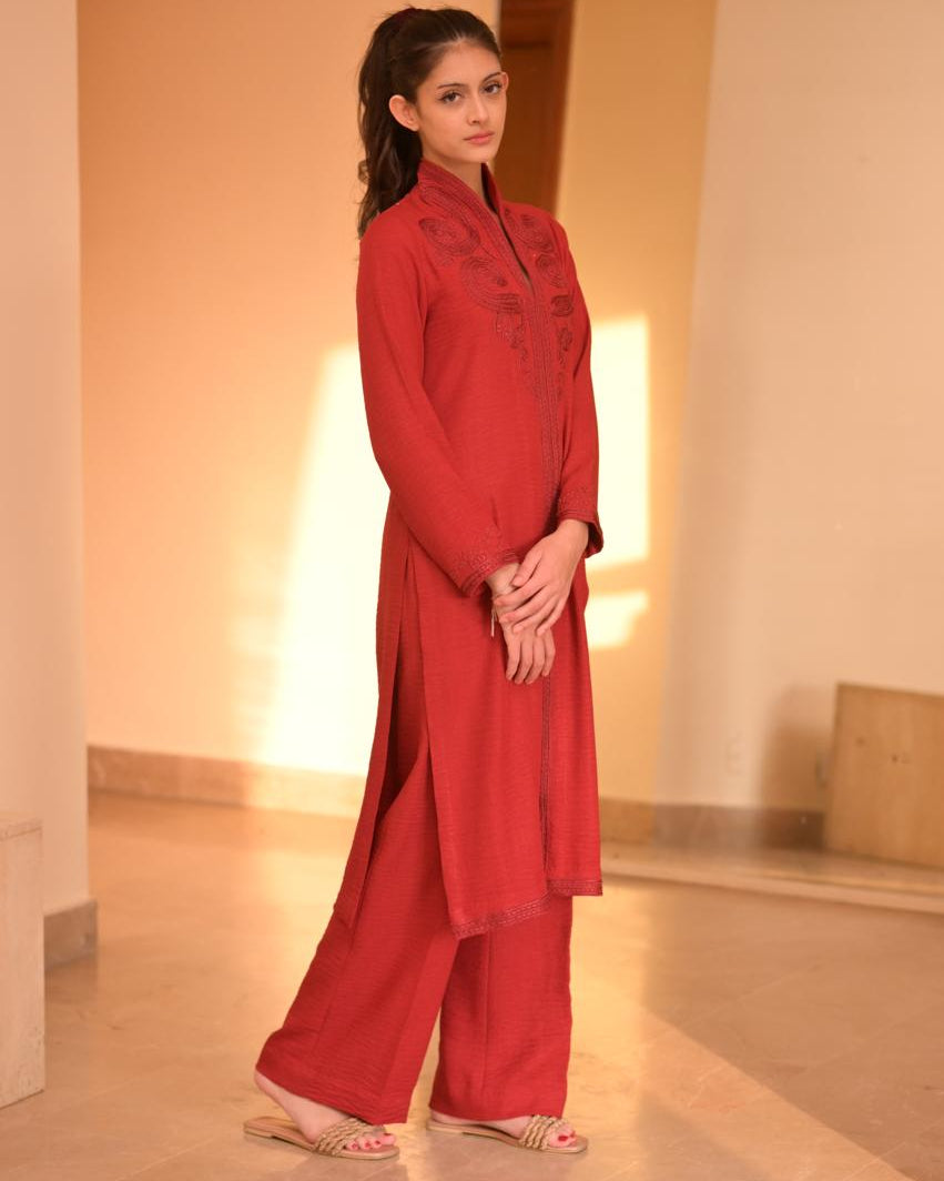 Red embroidered traditional outfit with a blurred background