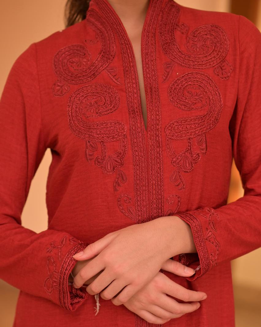 Red embroidered traditional outfit with a blurred background